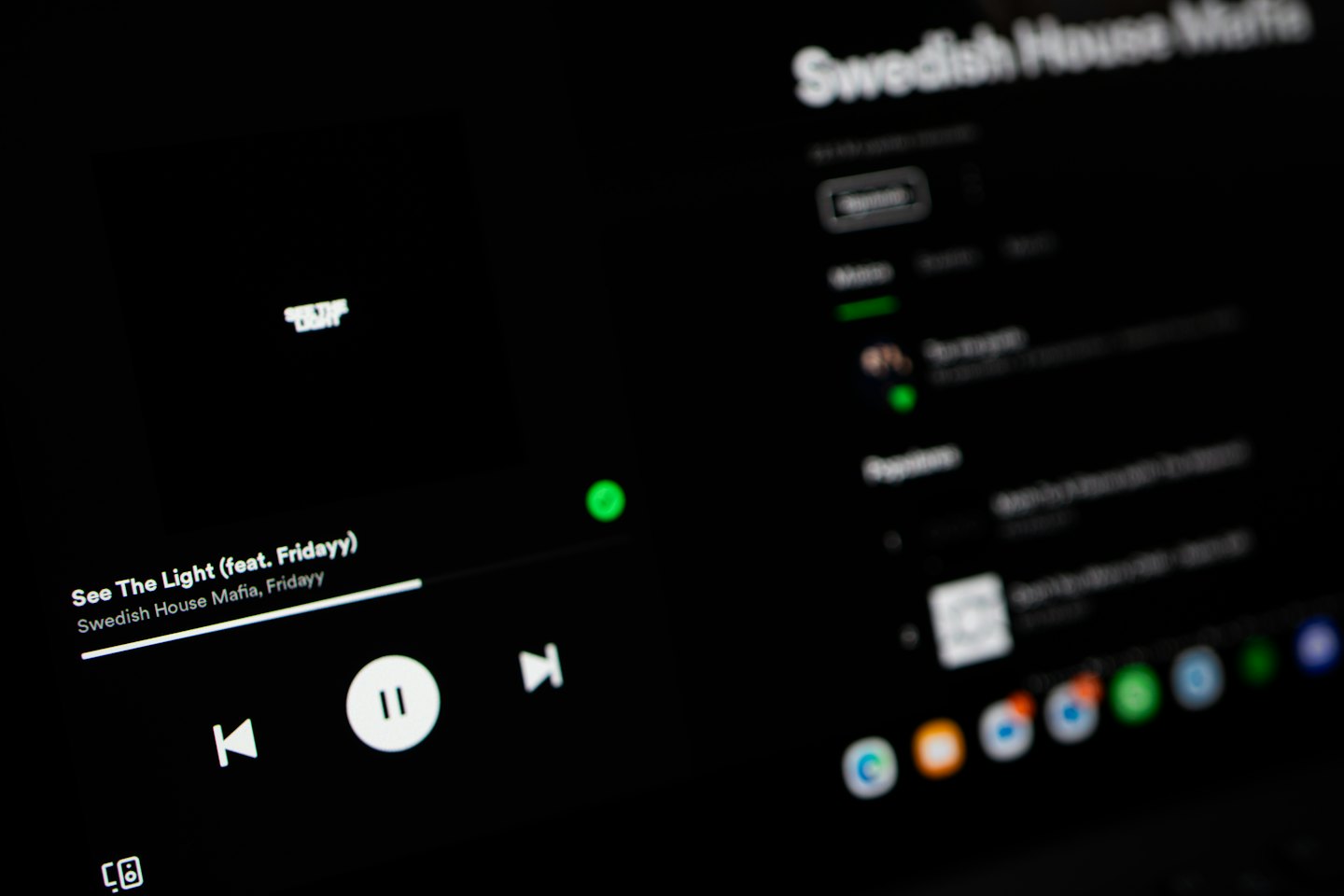 Music streaming interface on a dark digital screen.